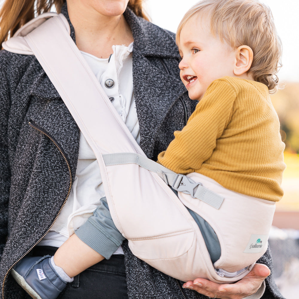 Mother carrying baby in a simple cross-body baby carrier