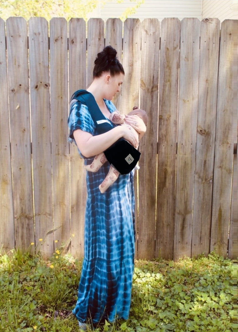 Side view of mother nursing her baby using Pick-Me-Up nurse sling